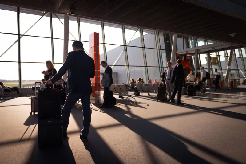 Packing for the Tropics: What a Physicist's Luggage Reveals About Career Stage and Collaboration Strategy
